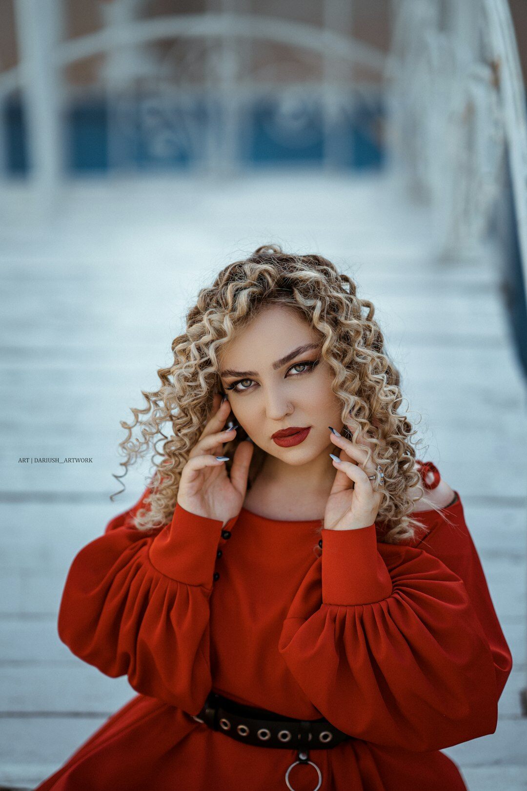 Studio portrait of a young Swiss woman with curly hair, data journalist